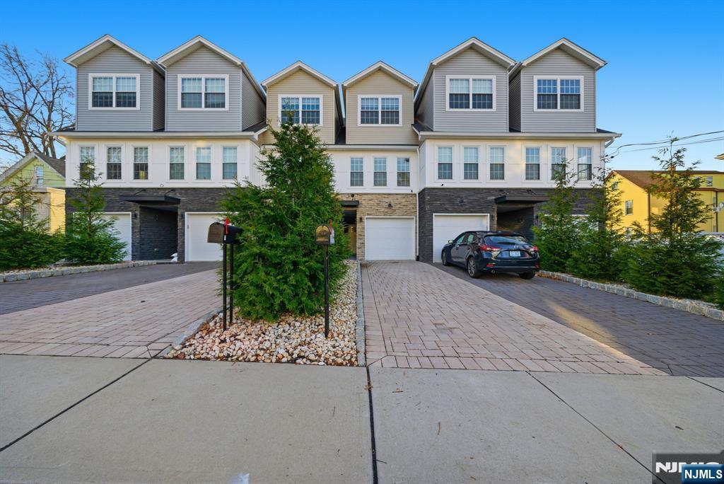 a car parked in front of a white house