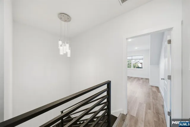 a front view of a house with a garden and parking space