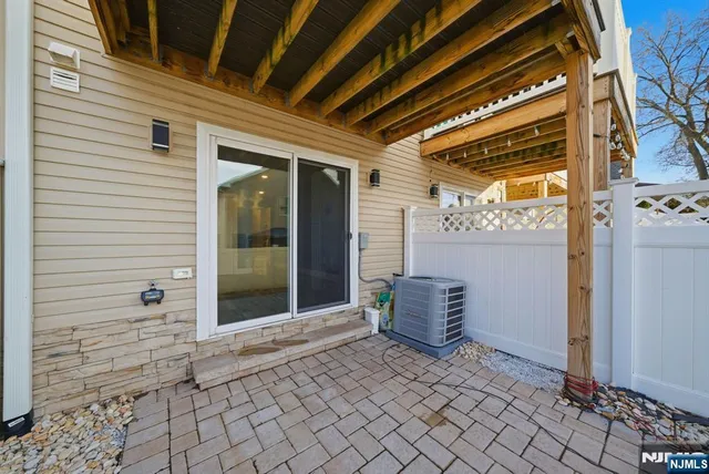 a view of a hallway with chair and chandelier