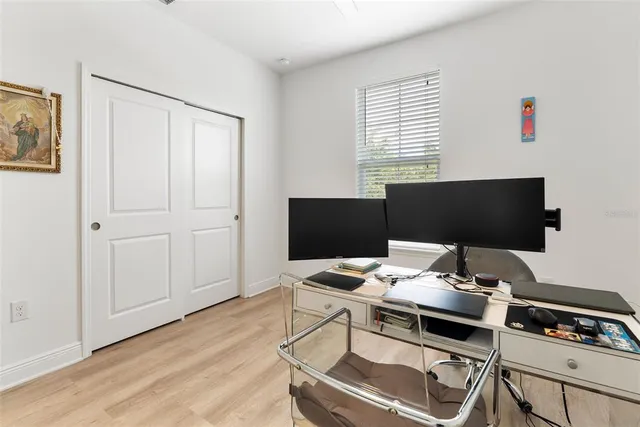 a bathroom with a granite countertop sink and a window