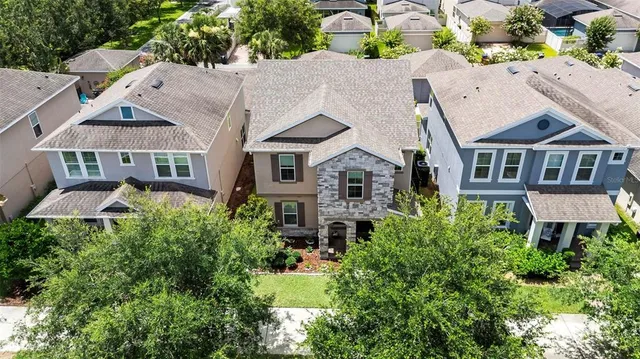 an aerial view of multiple houses with a yard