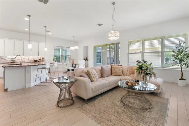 a living room with furniture and a chandelier