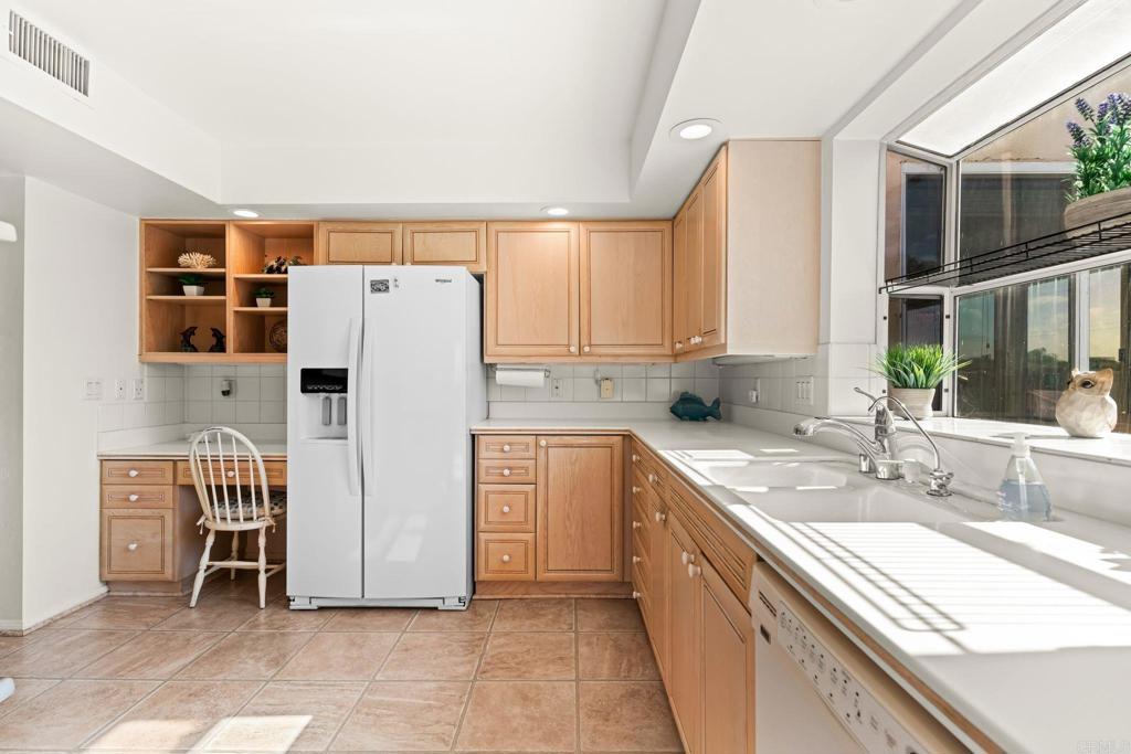 1105 Reed Avenue San Diego, CA 92109 - Photo 15 of 35 a kitchen with stainless steel appliances a refrigerator sink and cabinets