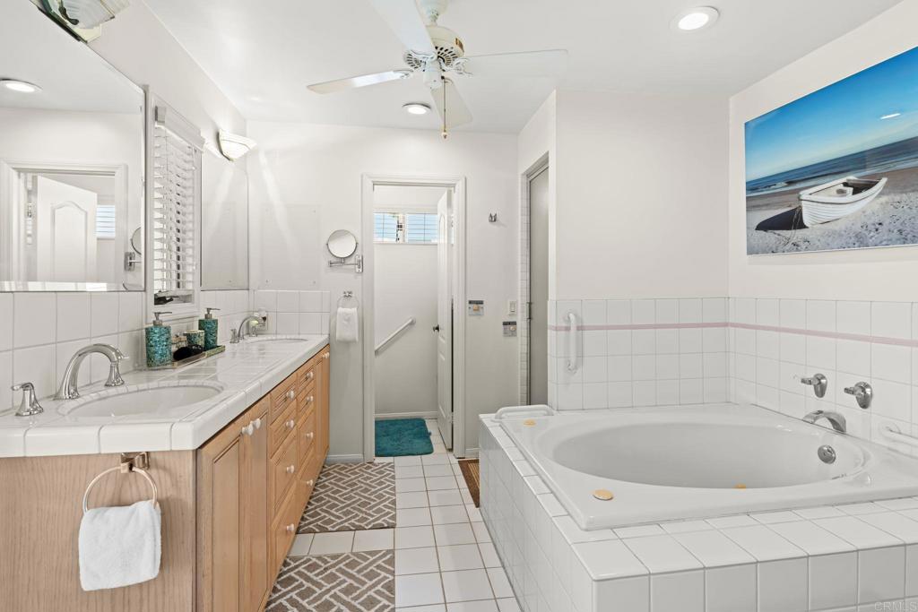 1105 Reed Avenue San Diego, CA 92109 - Photo 22 of 35 a spacious bathroom with a tub sink and mirror