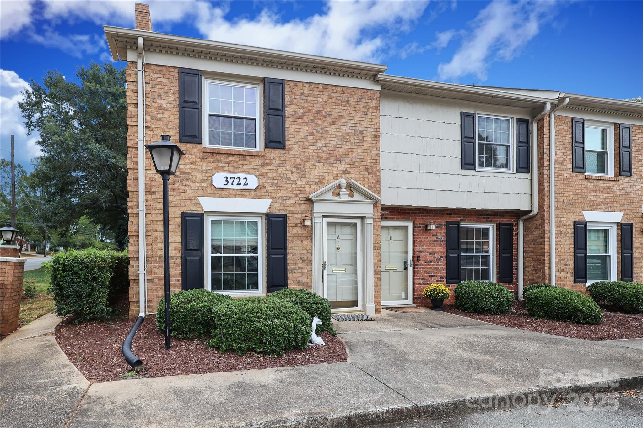 3722 Park Road, Unit B Charlotte, NC 28209 - Photo 1 of 48 a front view of a house with garden