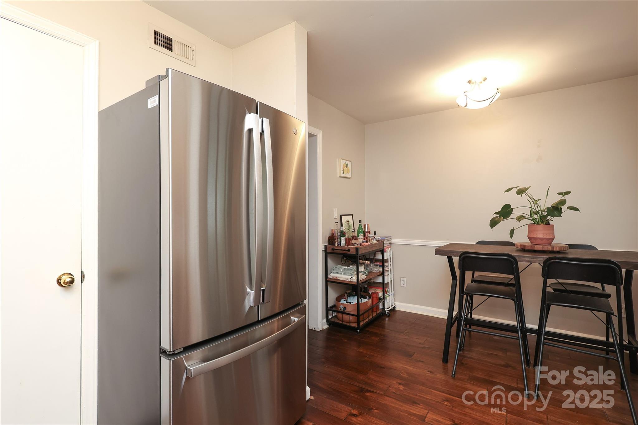 3722 Park Road, Unit B Charlotte, NC 28209 - Photo 11 of 48 a livingroom with dining area a chandelier a wooden table and chairs