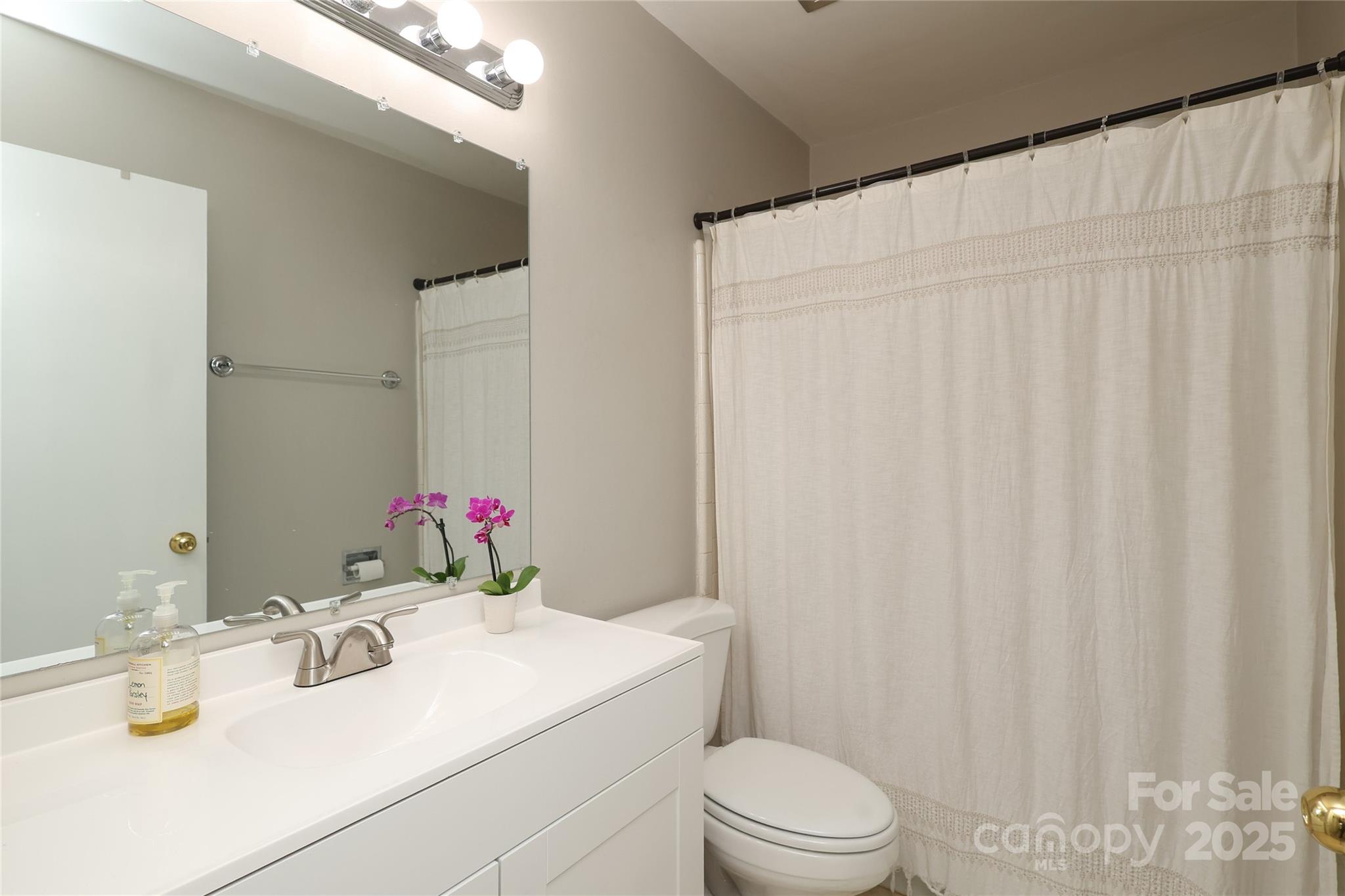 3722 Park Road, Unit B Charlotte, NC 28209 - Photo 23 of 48 a bathroom with a sink vanity mirror and toilet