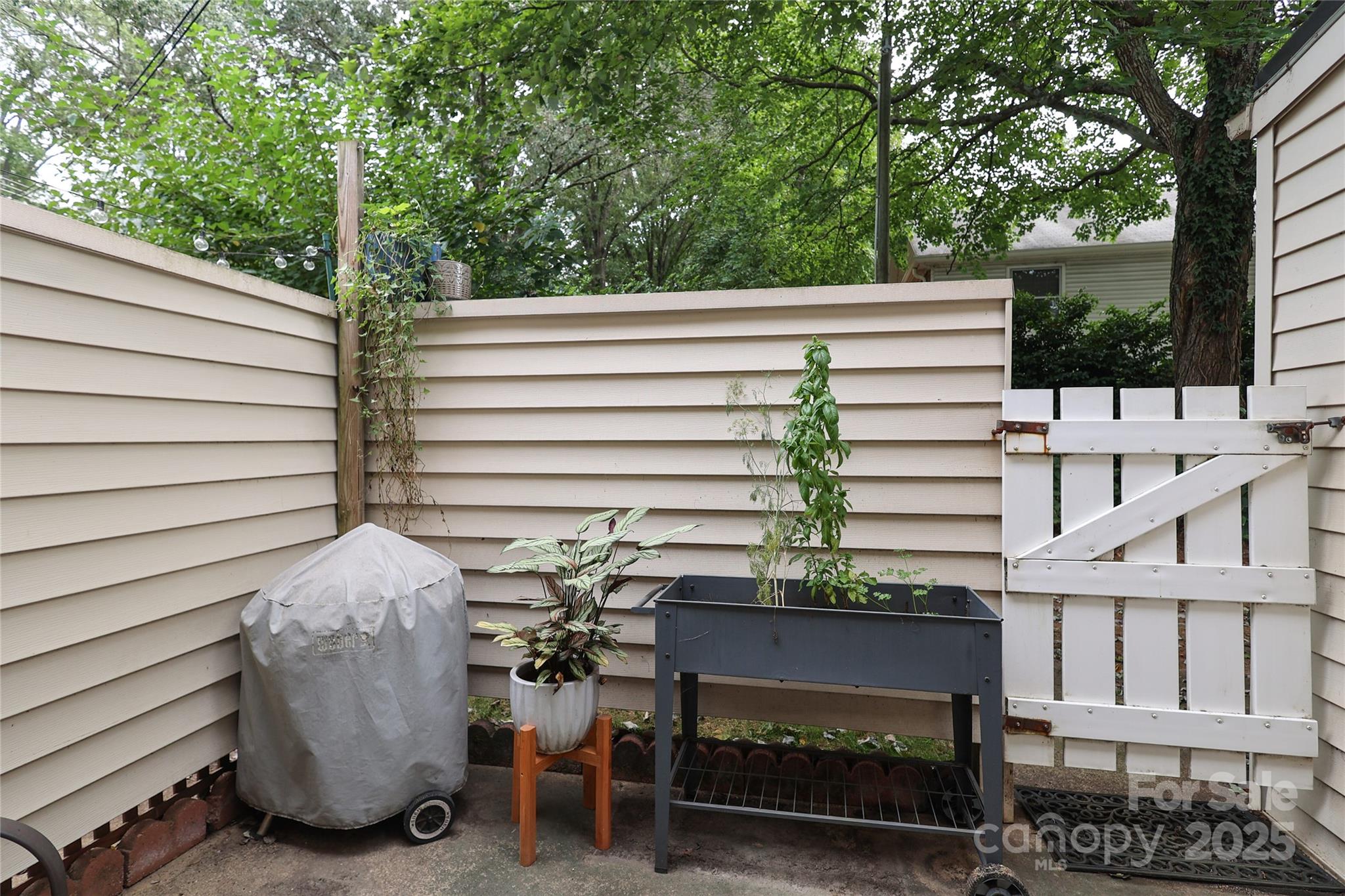 3722 Park Road, Unit B Charlotte, NC 28209 - Photo 24 of 48 a view of a patio with table and chairs with wooden floor and fence