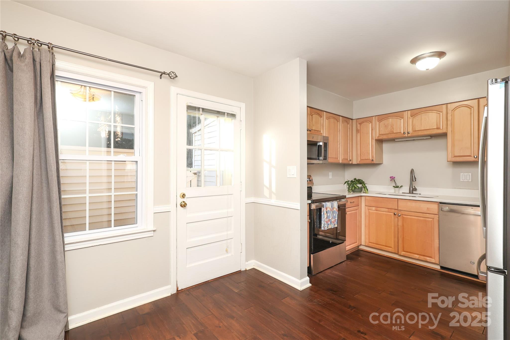 3722 Park Road, Unit B Charlotte, NC 28209 - Photo 32 of 48 a kitchen with granite countertop white cabinets and white appliances