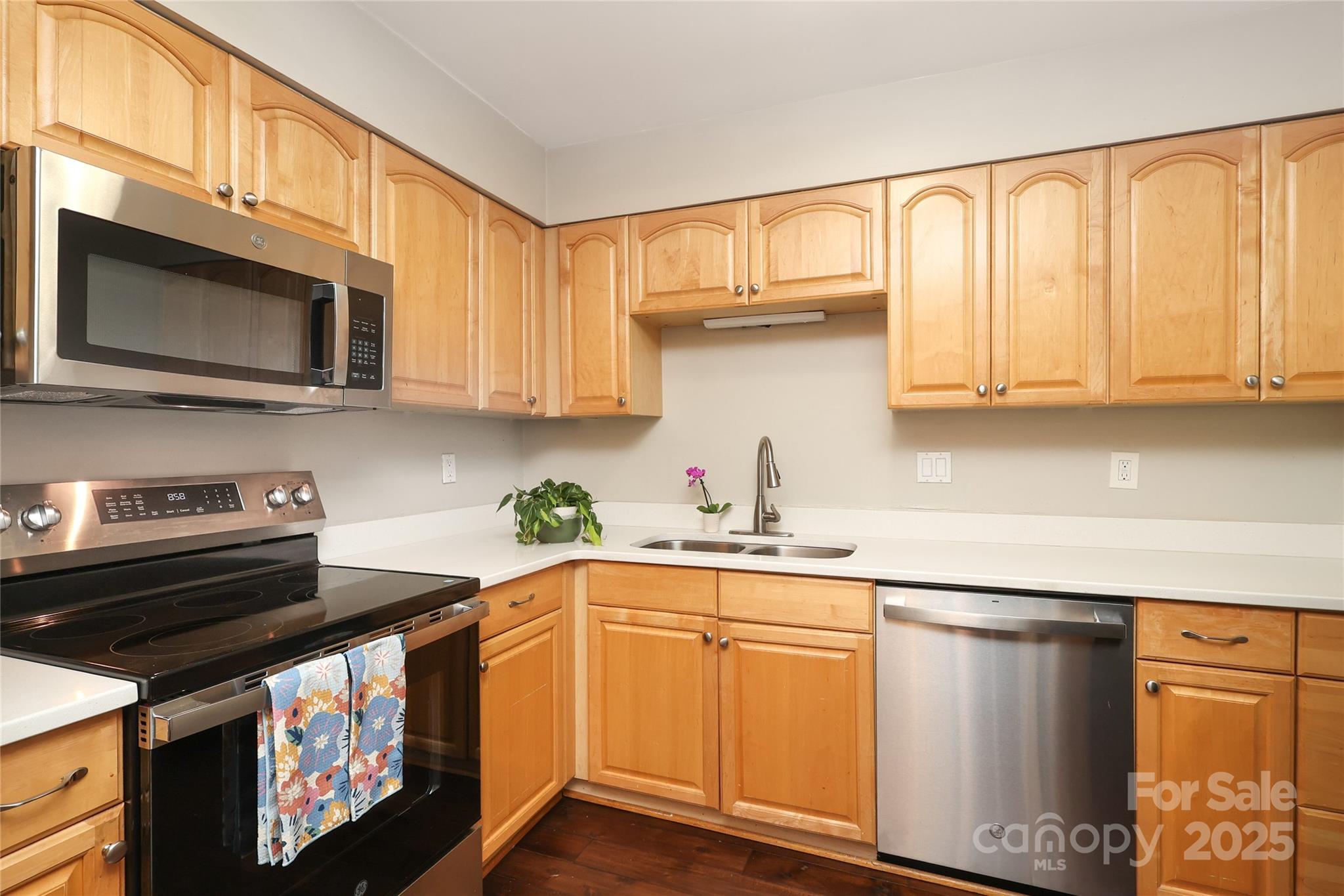 3722 Park Road, Unit B Charlotte, NC 28209 - Photo 33 of 48 a kitchen with stainless steel appliances granite countertop a stove a sink and a microwave