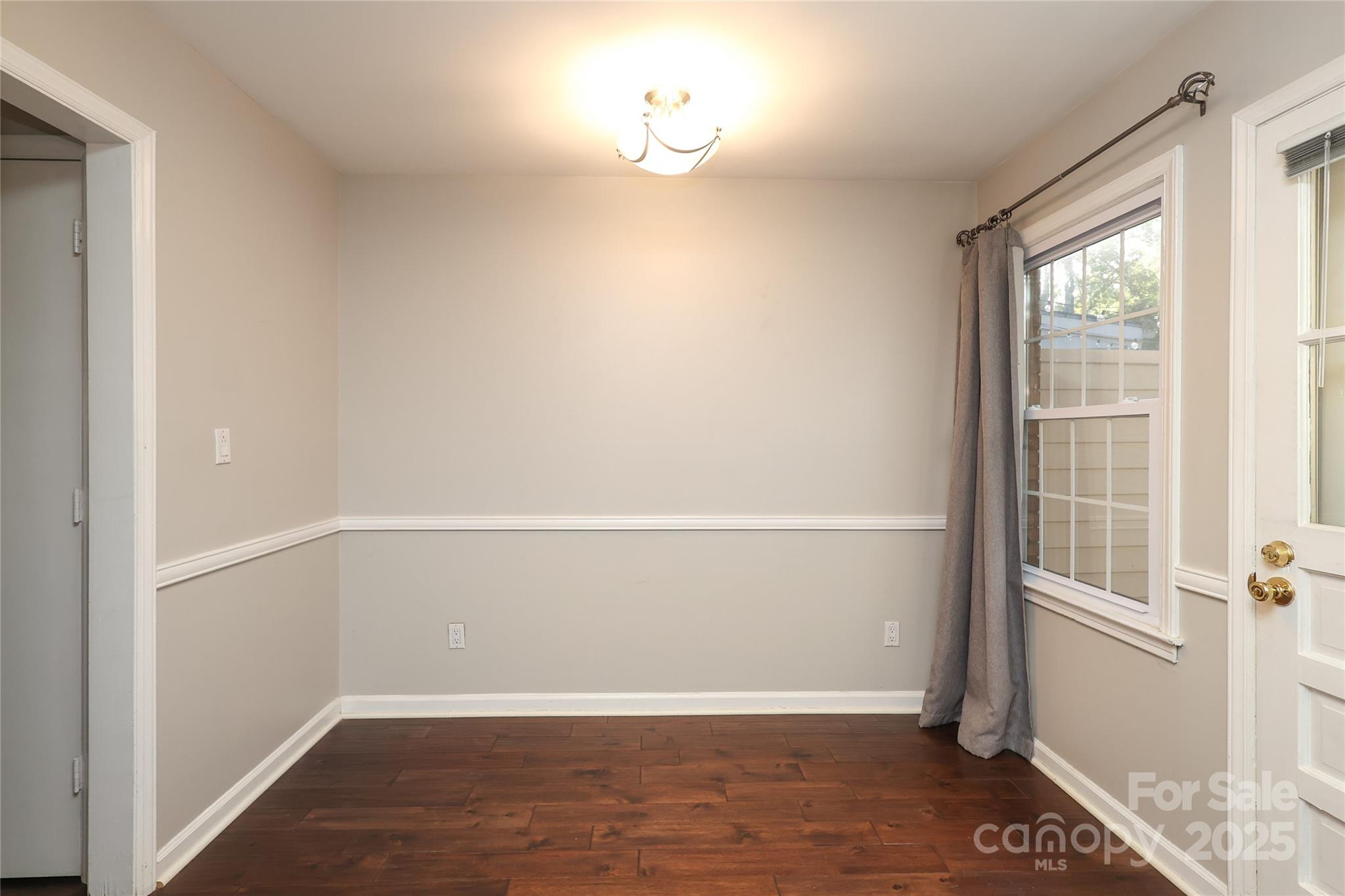 3722 Park Road, Unit B Charlotte, NC 28209 - Photo 34 of 48 an empty room with wooden floor and windows
