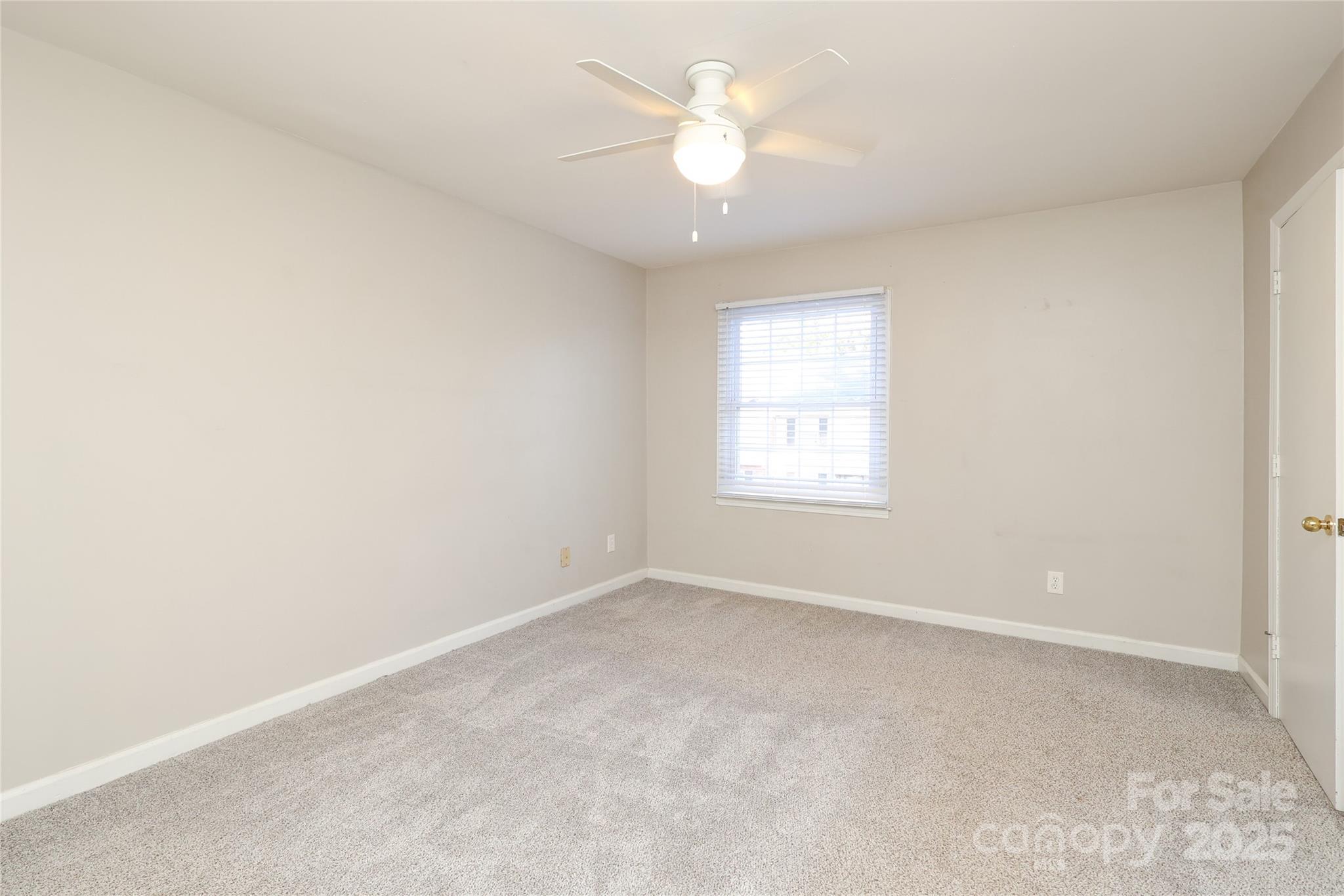 3722 Park Road, Unit B Charlotte, NC 28209 - Photo 38 of 48 an empty room with a window and a fan