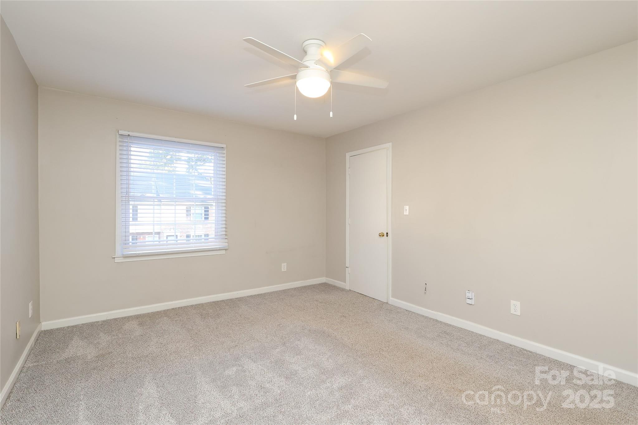 3722 Park Road, Unit B Charlotte, NC 28209 - Photo 39 of 48 an empty room with a window and a ceiling fan