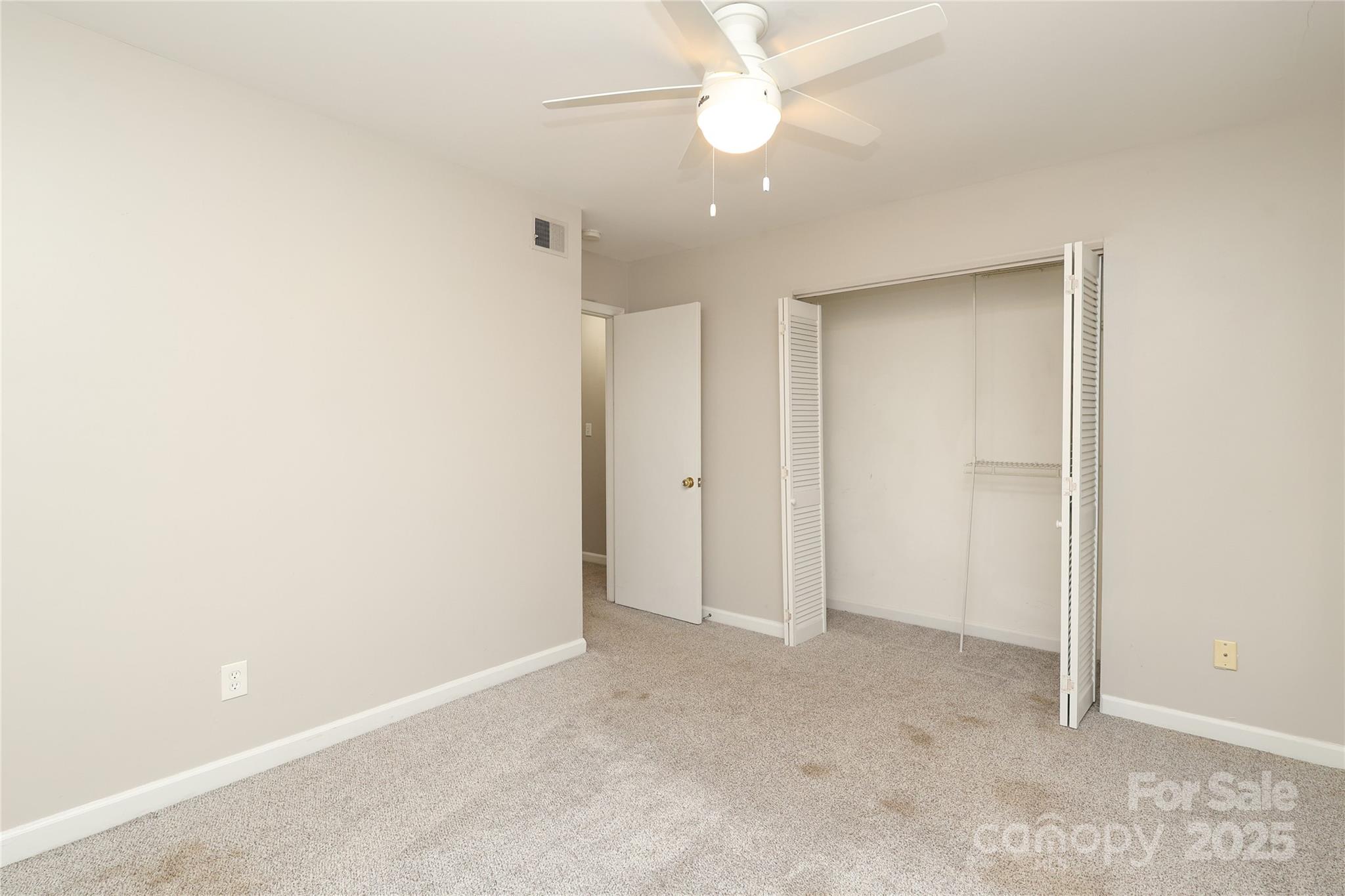 3722 Park Road, Unit B Charlotte, NC 28209 - Photo 43 of 48 an empty room with a ceiling fan and a window