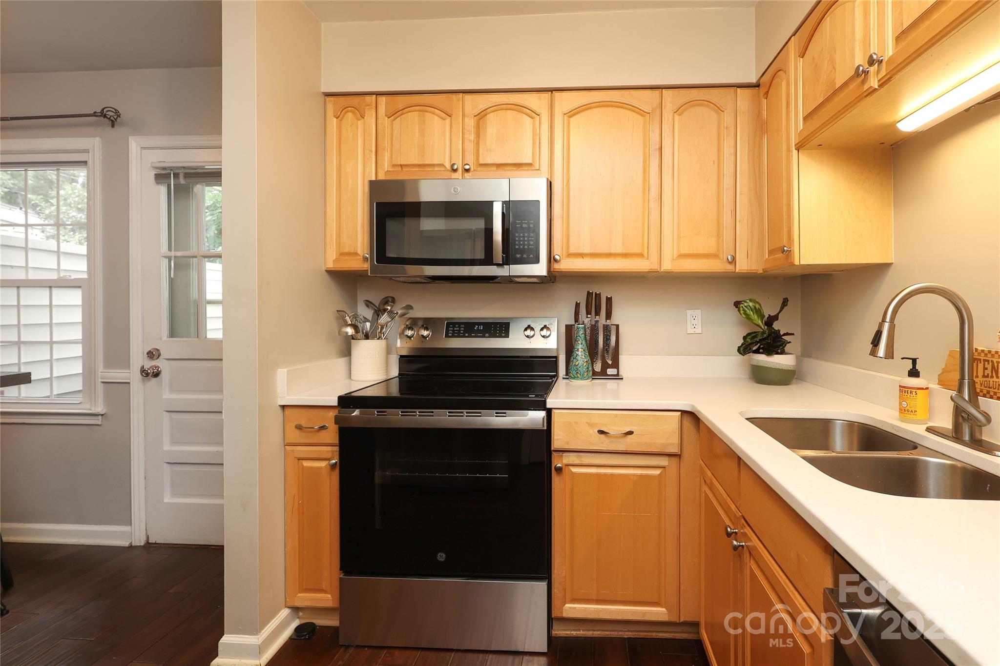 3722 Park Road, Unit B Charlotte, NC 28209 - Photo 10 of 48 a kitchen with a sink cabinets and a wooden floor