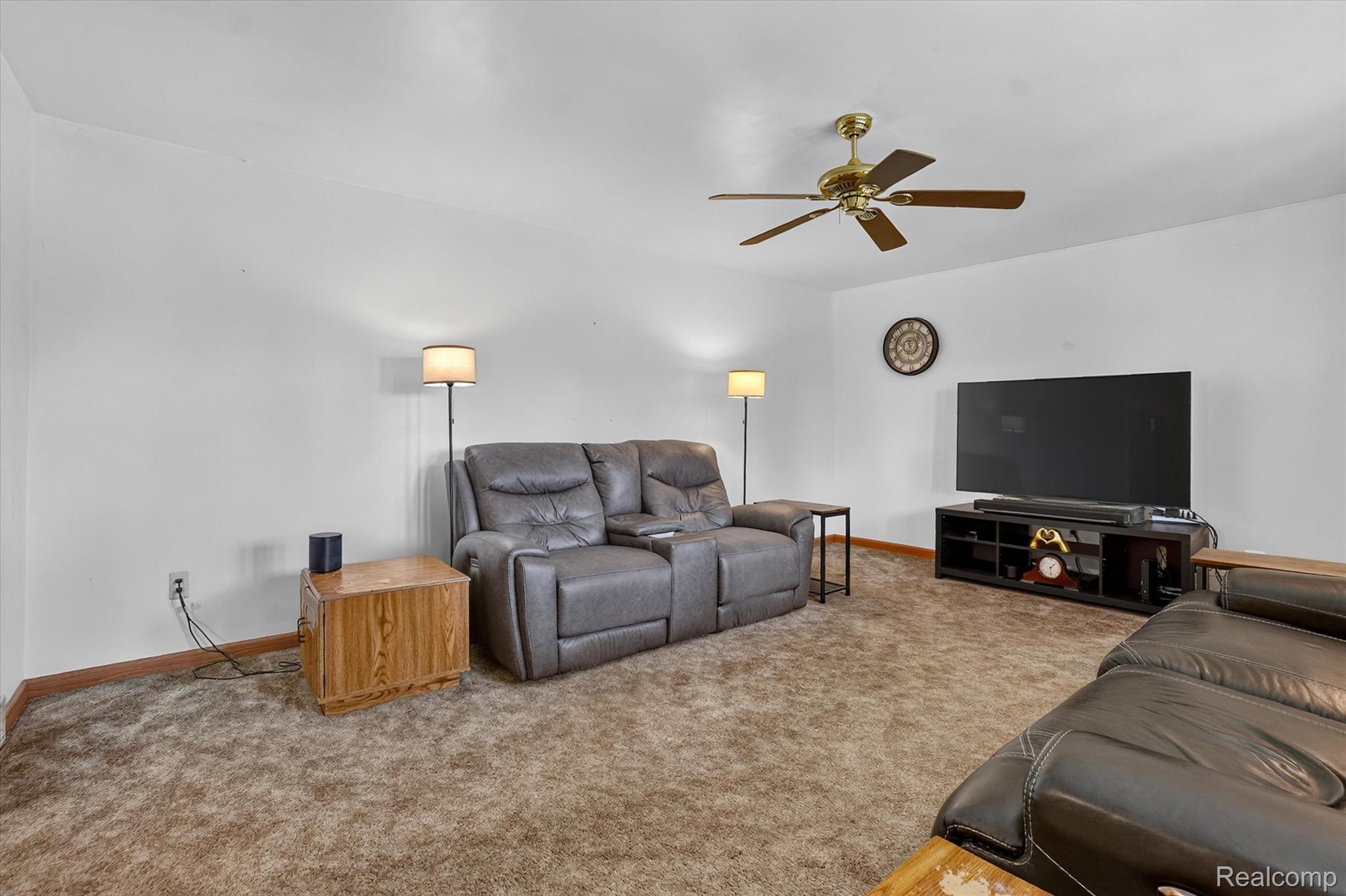 6895 Stow Road Fowlerville, MI 48836 - Photo 5 of 45 Carpeted living area featuring a ceiling fan, white walls, and floor lamps