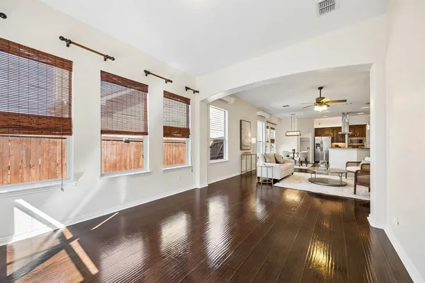 a view of a living room with furniture and wooden floor