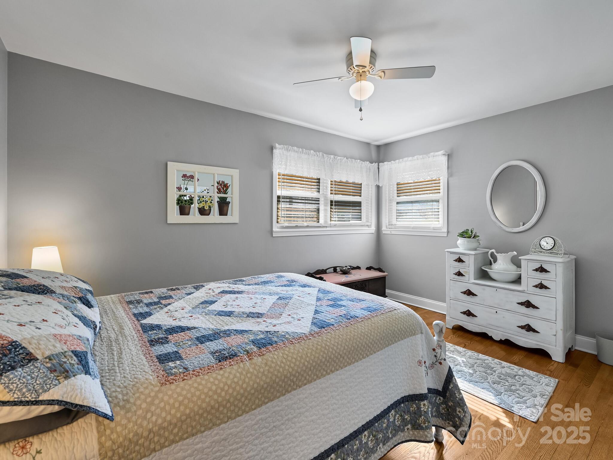 402 Balsam Road Hendersonville, NC 28792 - Photo 16 of 26 a bedroom with a bed a chandelier and a window