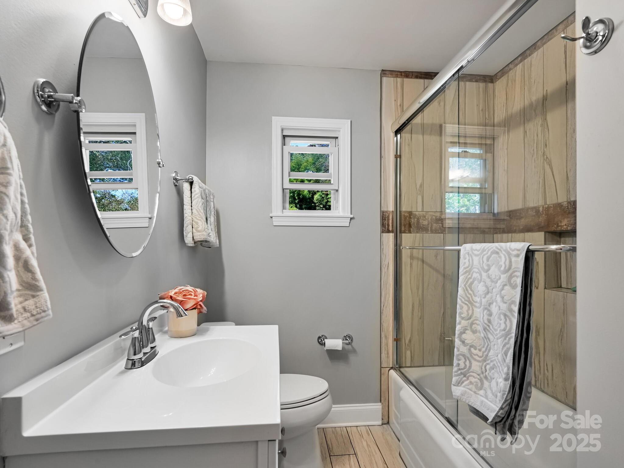 402 Balsam Road Hendersonville, NC 28792 - Photo 23 of 26 a bathroom with a sink toilet and shower