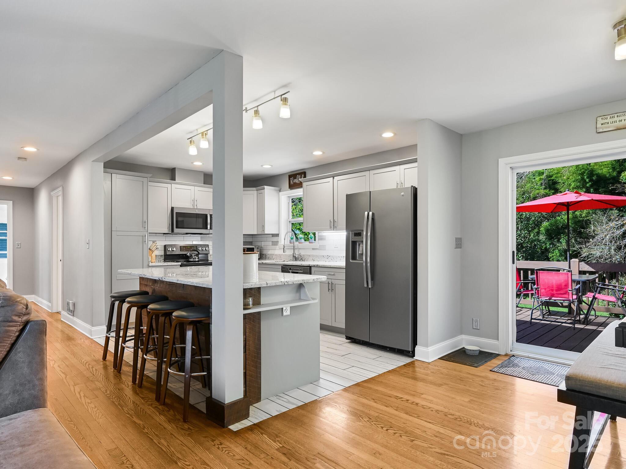 402 Balsam Road Hendersonville, NC 28792 - Photo 6 of 26 a kitchen with stainless steel appliances kitchen island granite countertop a refrigerator and a stove top oven