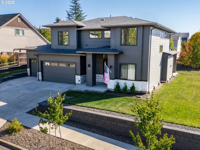 a front view of a house with a yard and a garden