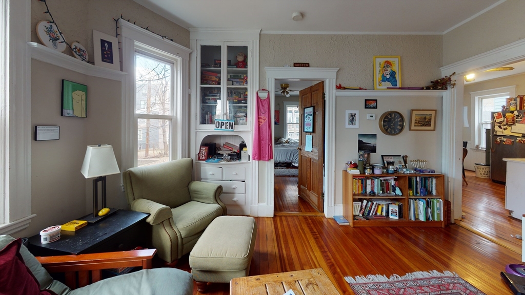 8 Olmstead Street, Unit 1 Boston, MA 02130 - Photo 3 of 11 a living room with furniture and a book shelf