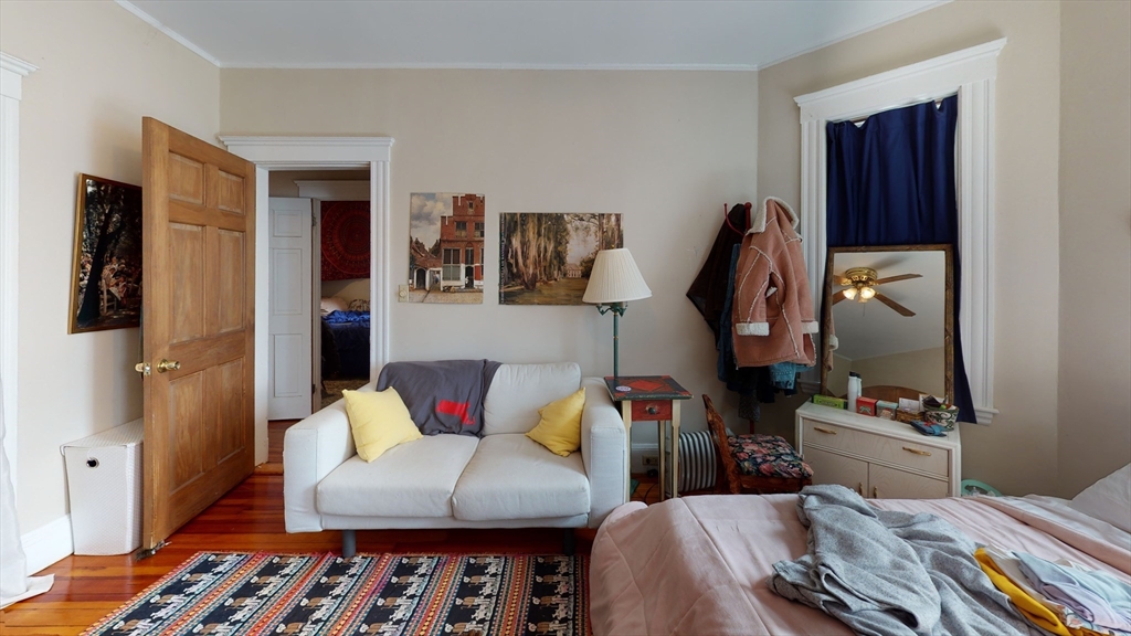 8 Olmstead Street, Unit 1 Boston, MA 02130 - Photo 4 of 11 a bedroom with furniture and a wooden floor