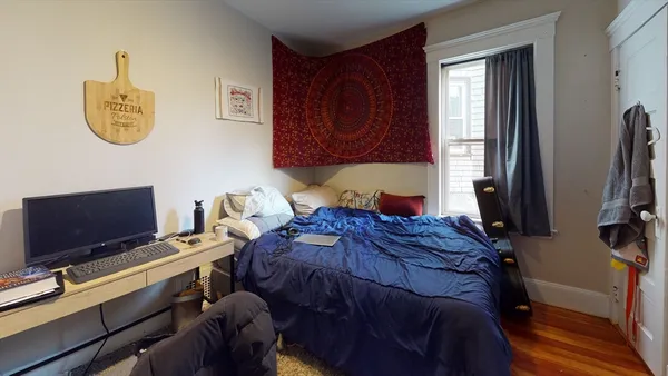 a bedroom with a bed and a flat screen tv