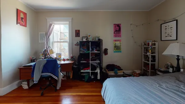 a bedroom with furniture and a window