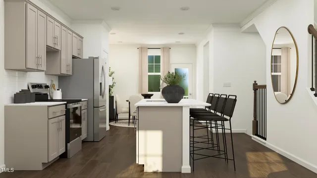 a kitchen with stainless steel appliances granite countertop a table chairs and a refrigerator