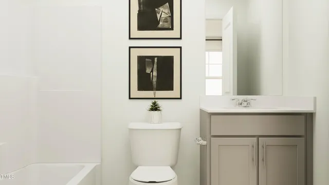 a bathroom with a sink toilet and mirror