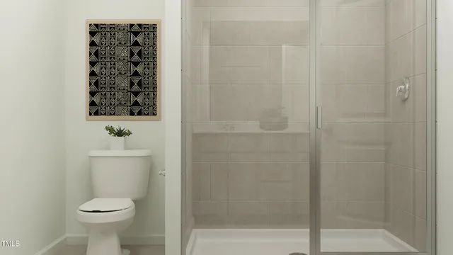 a bathroom with a toilet and a shower