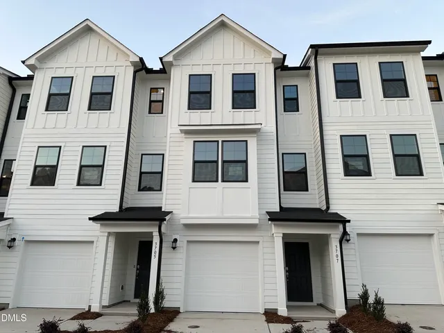 a view of a white house with large windows