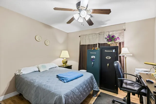 a bedroom with a bed and a chandelier