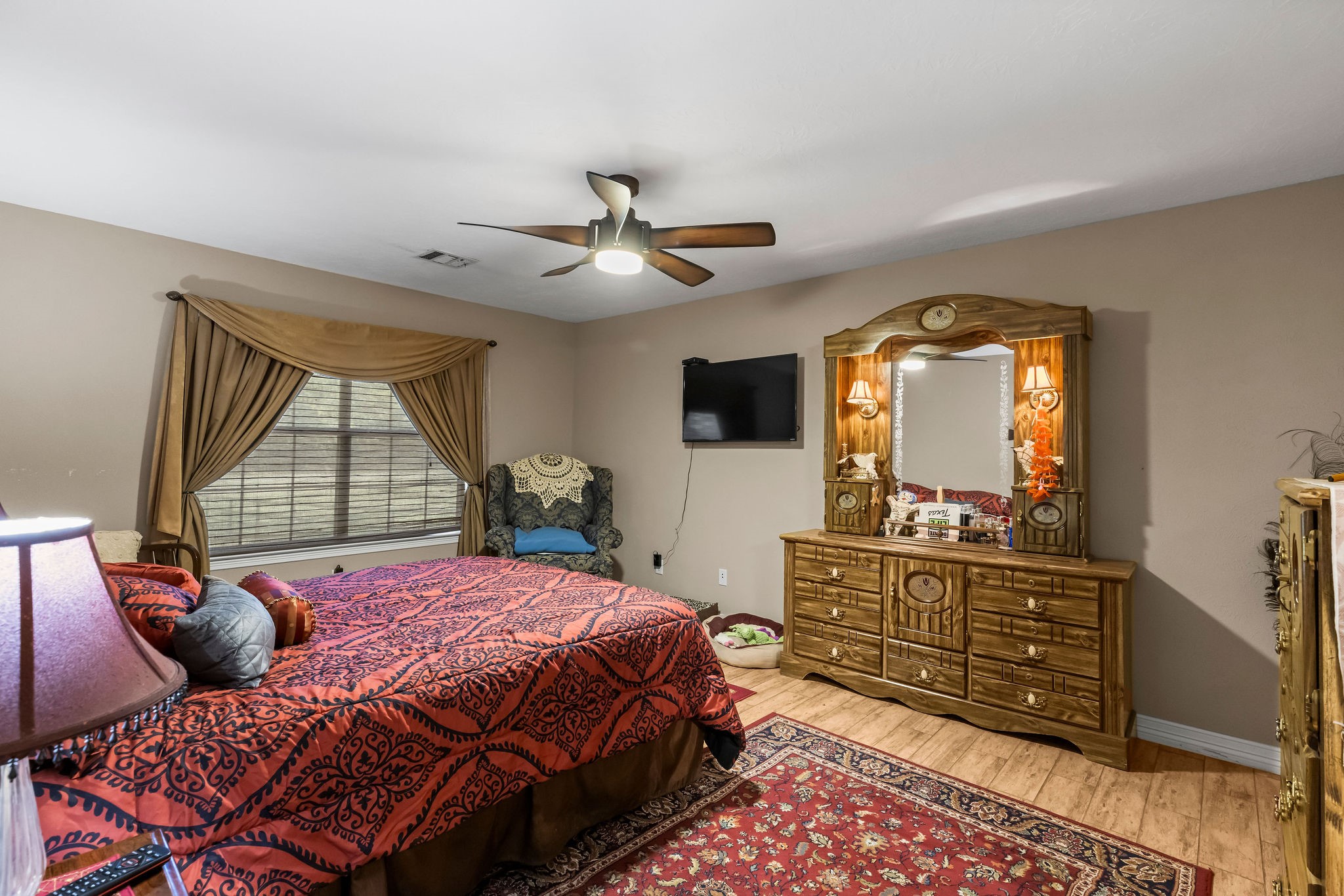 19094 FM 2854 Road Montgomery, TX 77316 - Photo 12 of 16 a bedroom with a bed a dresser and mirror