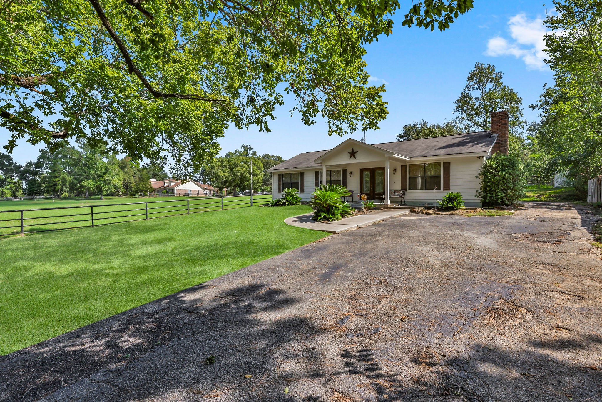 19094 FM 2854 Road Montgomery, TX 77316 - Photo 2 of 16 a front view of a house with a yard