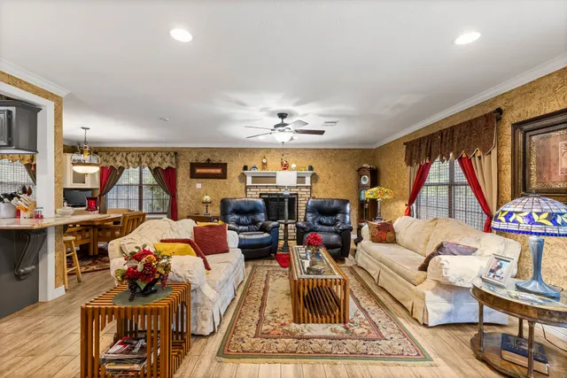 a living room with furniture a rug and a flat screen tv