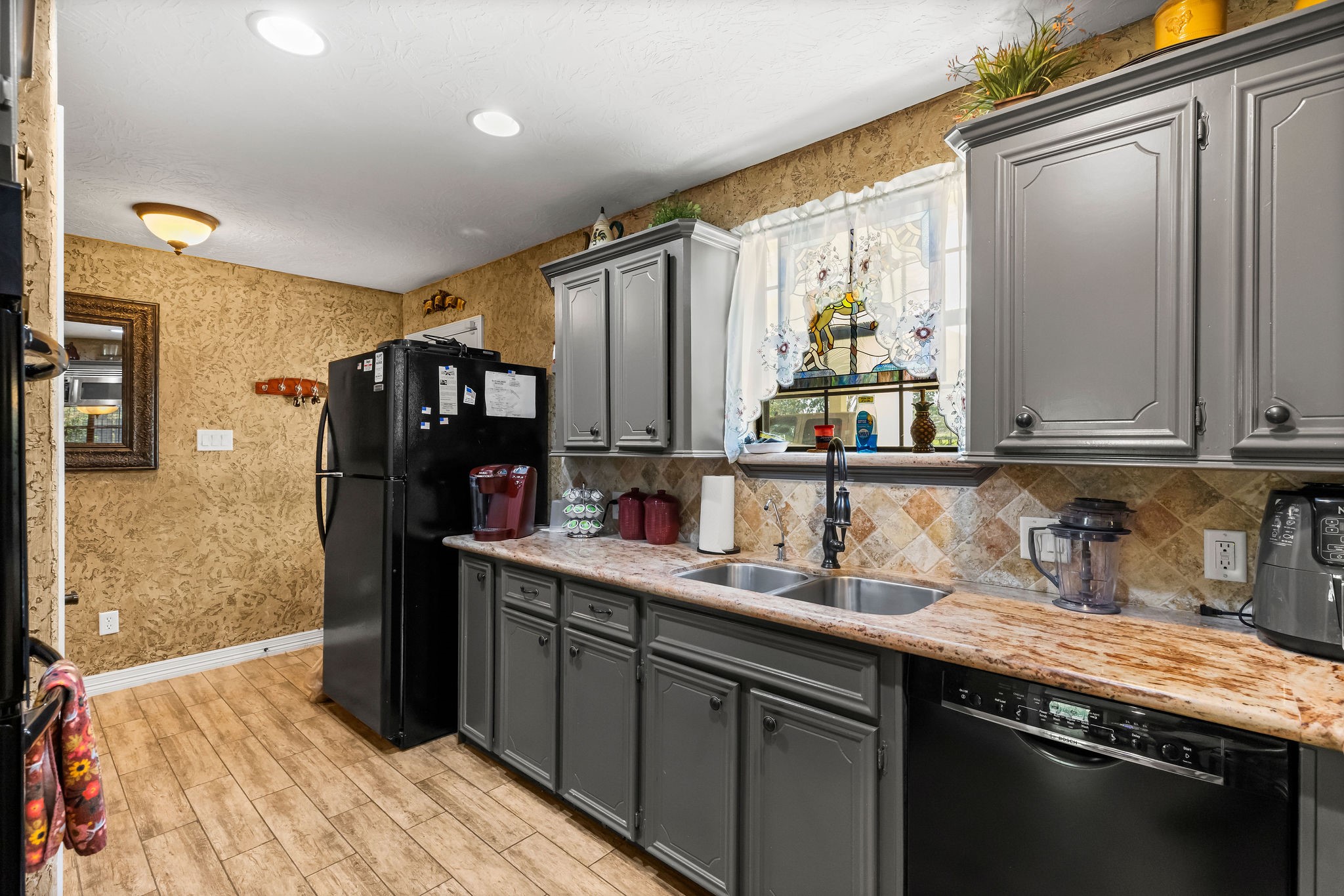 19094 FM 2854 Road Montgomery, TX 77316 - Photo 9 of 16 a kitchen with stainless steel appliances granite countertop a sink refrigerator and cabinets