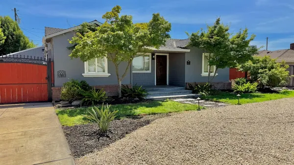 a front view of a house with a yard and outdoor seating