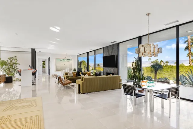a dining room with furniture a chandelier and a rug