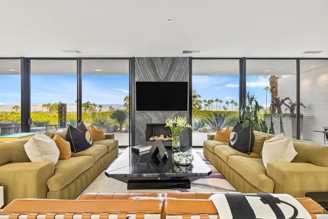 a living room with furniture and a potted plant