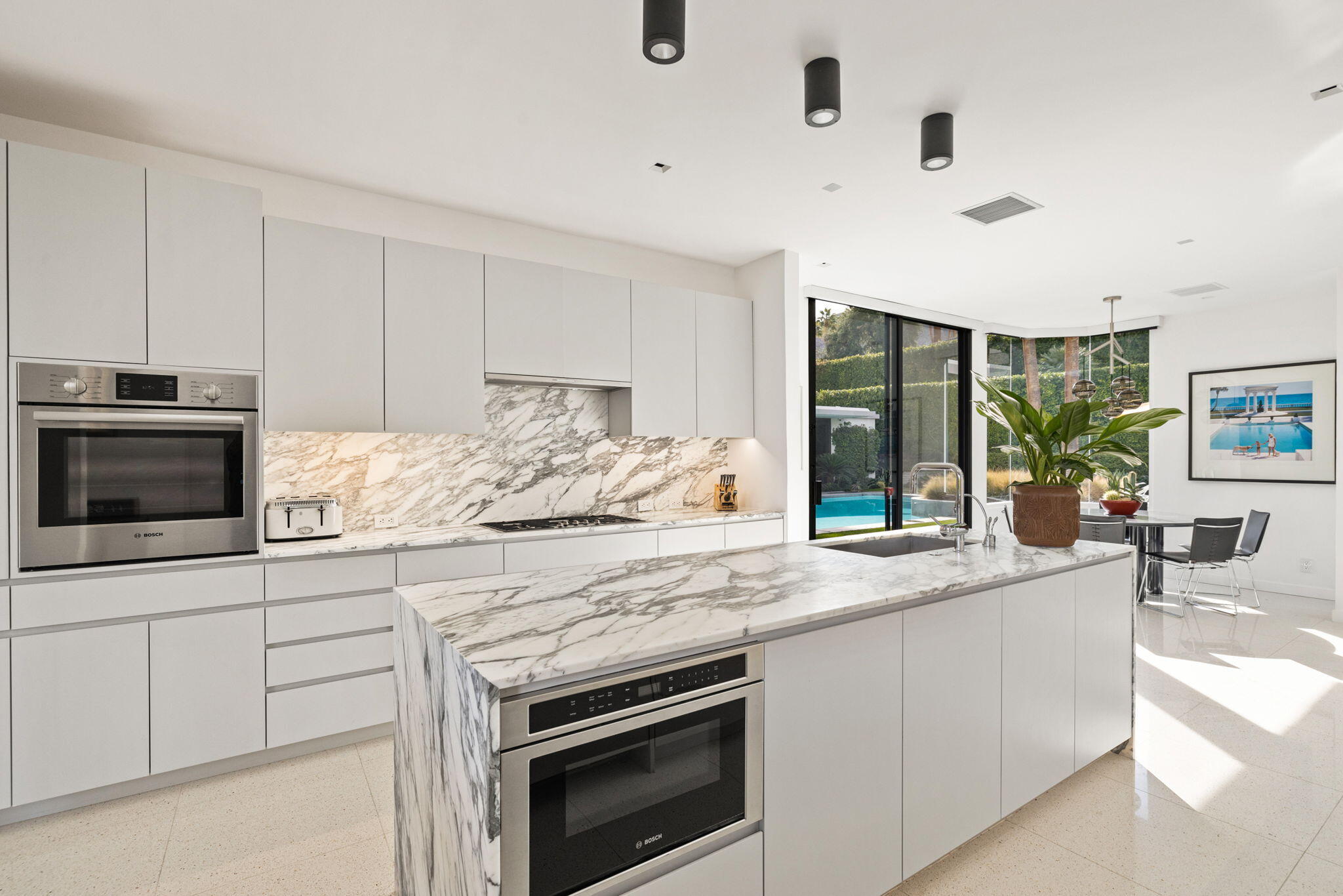 70149 Sonora Road Rancho Mirage, CA 92270 - Photo 24 of 74 a kitchen with granite countertop white cabinets and white appliances