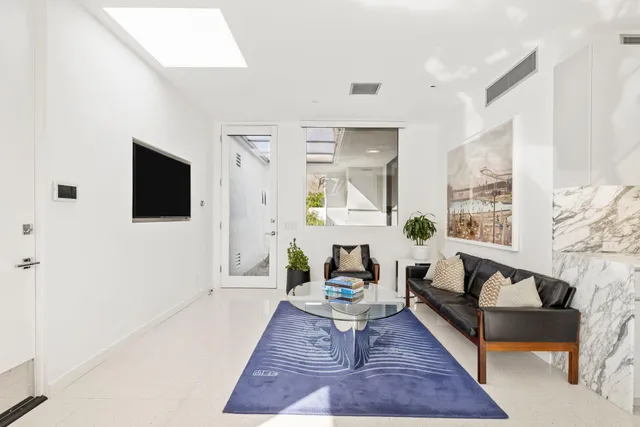 a spacious bathroom with a double vanity sink and a large mirror next to a shower