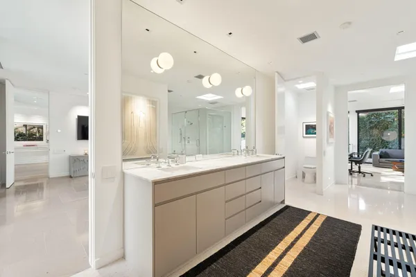 a bedroom with a large bed and a large window