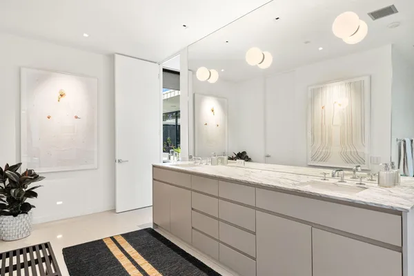 a bathroom with a granite countertop sink mirror and toilet
