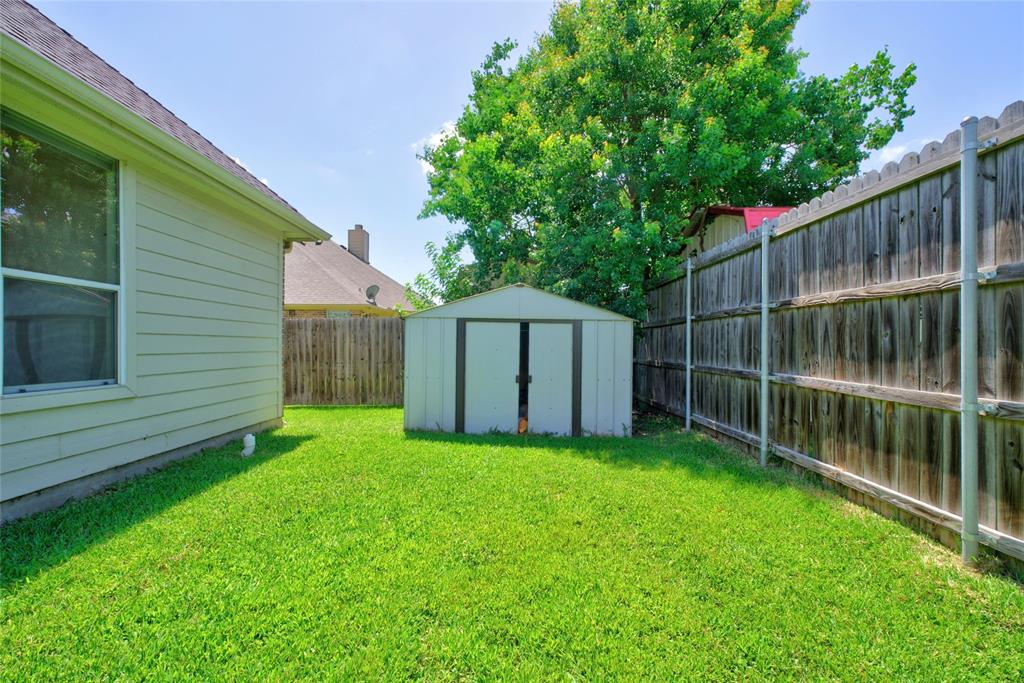 517 Austin Acre Road Sulphur Springs, TX 75482 - Photo 22 of 23 a view of a backyard with a cabin and wooden fence