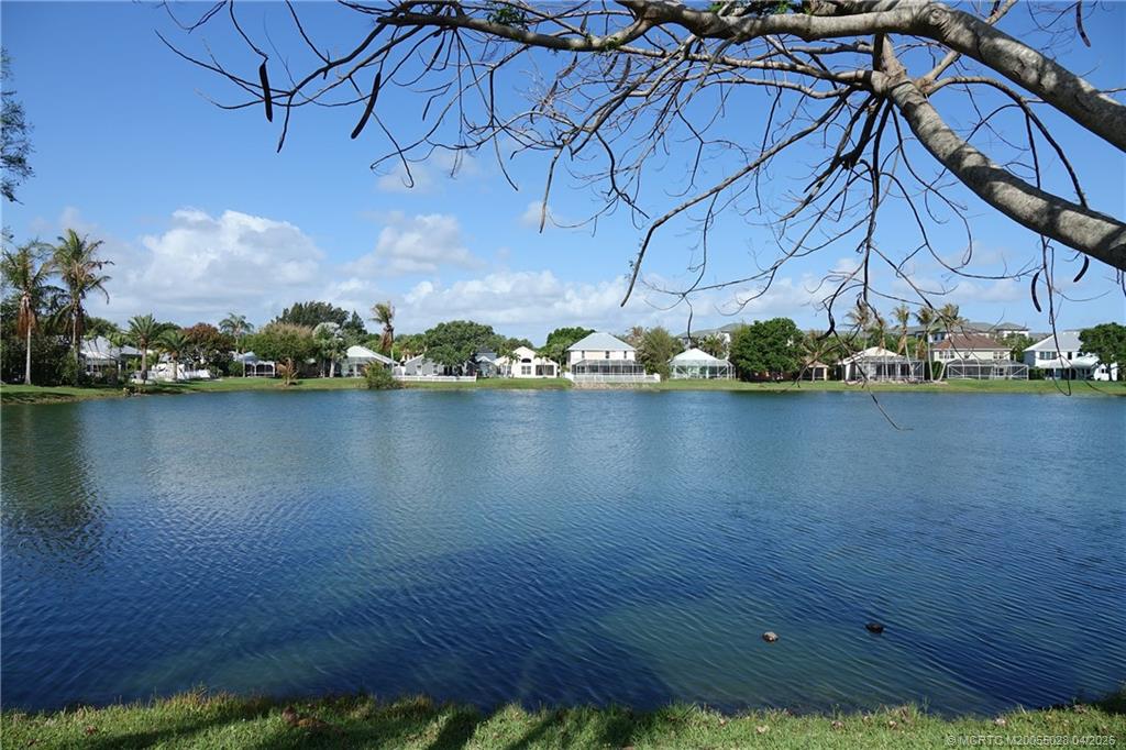 2120 Northwest Marsh Rabbit Lane Jensen Beach, FL 34957 - Photo 5 of 34 a view of a lake with a building in the background
