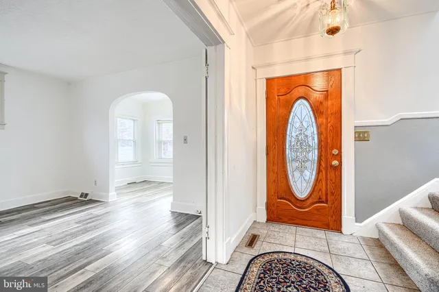 a view of a livingroom with wooden floor and furniture