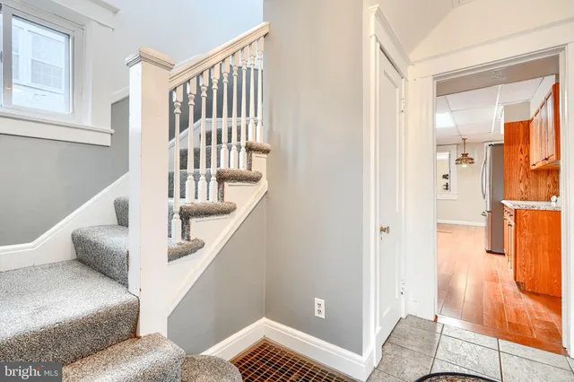 a view of entryway and hall with wooden floor