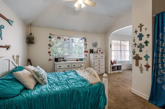 a bedroom with bed and a chandelier